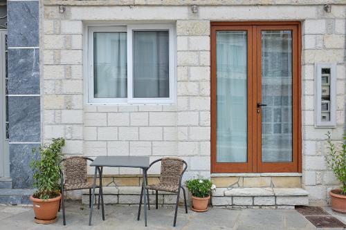 a table and chairs in front of a house at Alexis House Studio in Pylos