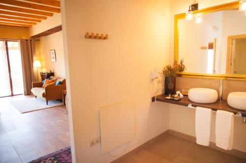 a bathroom with two sinks and a mirror at Mas del Bot in Valderrobres