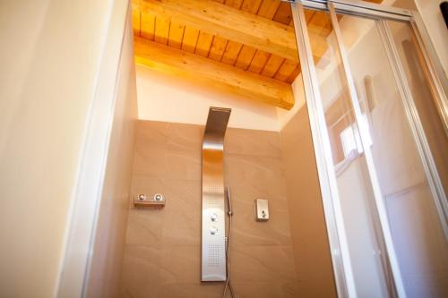 a door leading into a bathroom with a wooden ceiling at Mas del Bot in Valderrobres