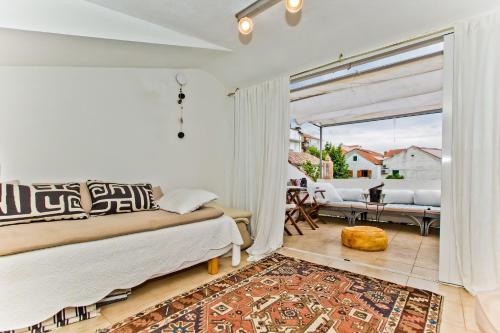 a living room with a bed and a patio at Villa Sunce in Hvar