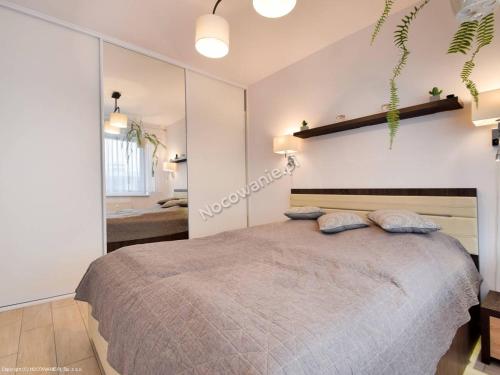 1 dormitorio con 1 cama grande y 2 almohadas en LUX Apartamenty Bliżej Morza Kołobrzeg, en Kołobrzeg