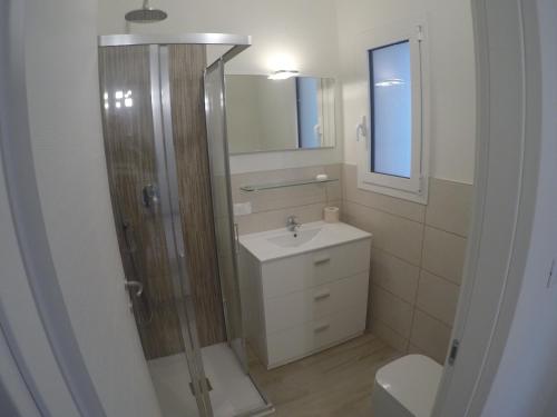 a bathroom with a shower and a sink and a toilet at New Alfieri - Agenzia Cocal in Caorle