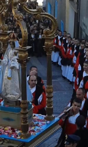 a group of people dressed in costumes in a church at Antico Restauro in Fonni