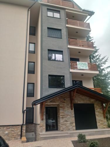 a tall apartment building with awning in front of it at Apartman Nana Svetogorska 19 ,stan 17 in Zlatibor