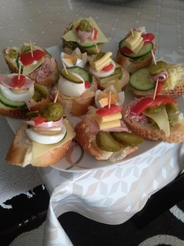 a plate of sandwiches with cheese and toppings at Apartments Zuto in Ulcinj