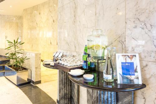 a lobby with a table with a bottle on it at Radisson Blu Hotel Lisbon in Lisbon
