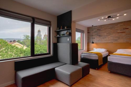 a bedroom with two beds and a large window at B&P studios in Varna City