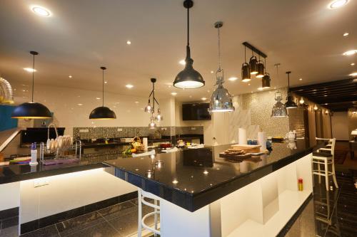a kitchen with a black counter top in a room at Ahn-Yi Residence in Brinchang