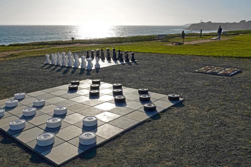 a chess board on the beach with a group of people at Cavalier Oceanfront Resort in San Simeon