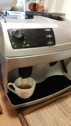 a coffee maker is making a cup of coffee at Wannamas Chiangmai Boutique House in Chiang Mai