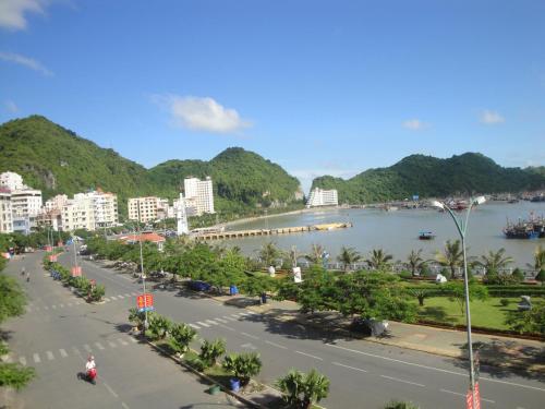 a view of a city with a river and mountains at Phuong Mai Family Hotel in Cat Ba