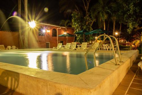 a swimming pool at night with a slide in it at Casa Hotel Guaracú in Santa Fe de Antioquia
