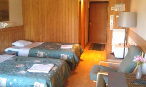 Ένα ή περισσότερα κρεβάτια σε δωμάτιο στο Hotel Tulikettu