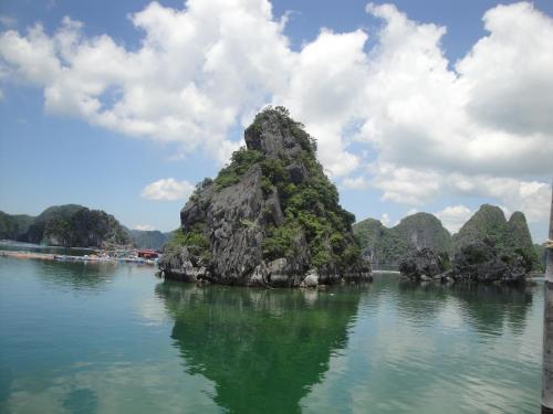 a large rock formation in the water on a lake at Phuong Mai Family Hotel in Cat Ba