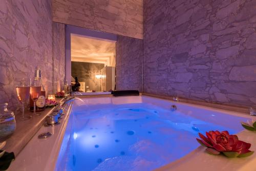 a jacuzzi tub with blue water in a room at The Dream in Marina di Carrara