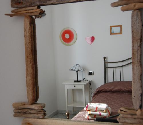 a bedroom with a bed and a table with a lamp at I Ginepri B&B in Portoscuso