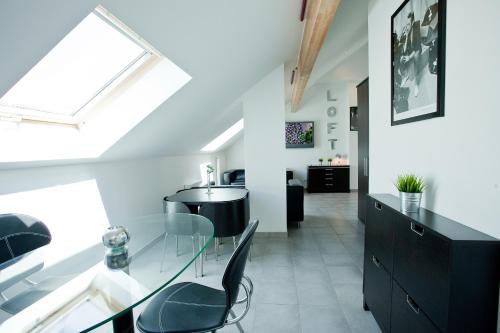 a dining room with a glass table and black cabinets at Résidence Le Patricia in Grenoble