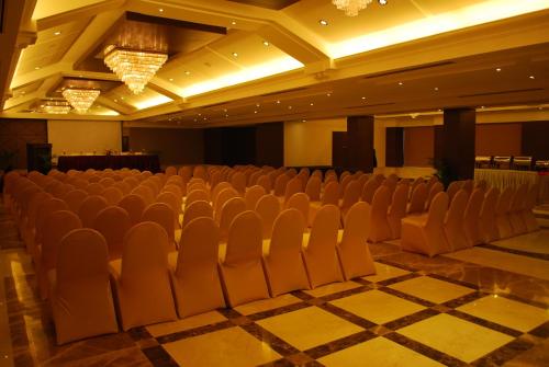 an auditorium with rows of chairs in a room at Beverly Hotel in Chennai