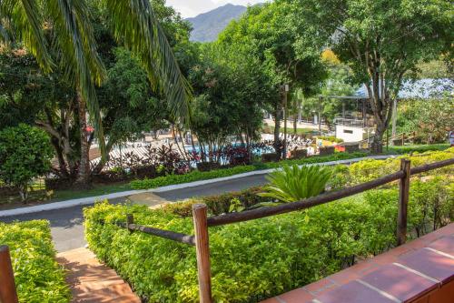 a road in a park with trees and a fence at Hosteria Guaracú in San Jerónimo