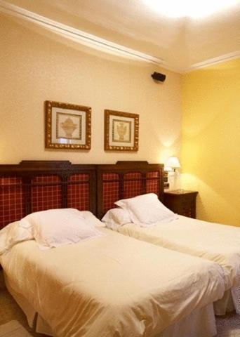 Postel nebo postele na pokoji v ubytování Hotel Juanito