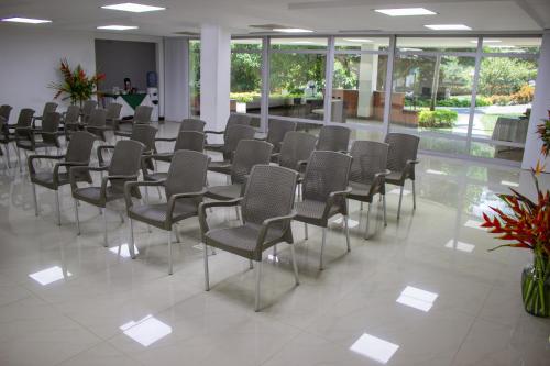 a row of chairs in a room with windows at Hosteria Guaracú in San Jerónimo