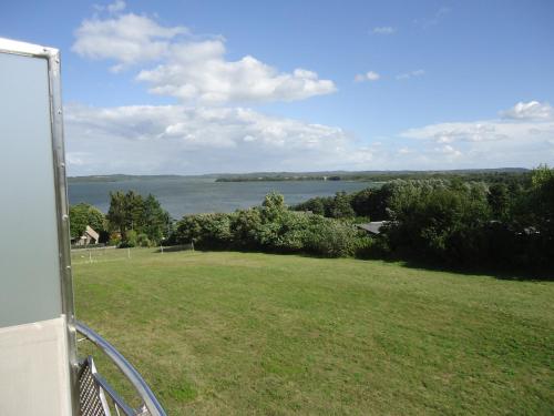 a view of the water from the balcony of a house at Inselhotel kleiner Bodden in Buschvitz
