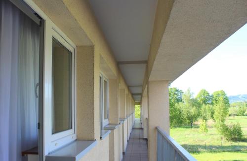 an empty corridor of a building with a window at Hotel Biały in Wałbrzych