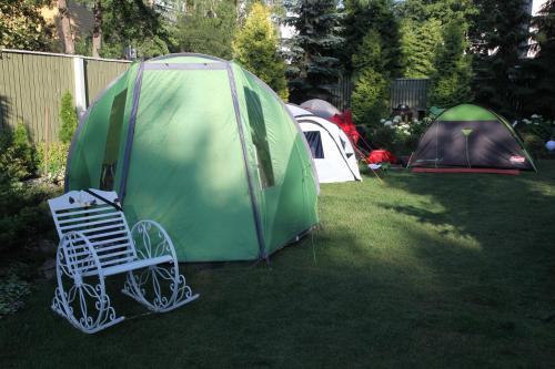 a group of tents and a chair in a yard at Garden Clamping in Tallinn