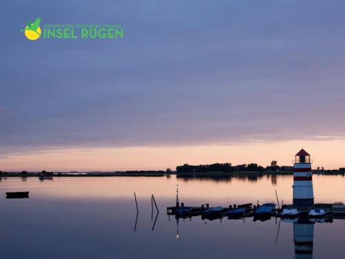 a lighthouse in the middle of a body of water at Jugendtours-Feriendorf Ummanz in Ummanz