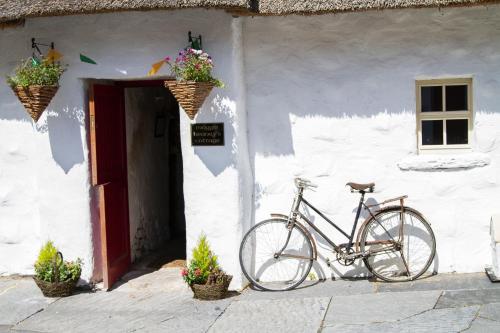 a bike parked in front of a white building at Loughcrew Glamping in Oldcastle