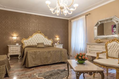 a bedroom with a bed and a mirror and a table at Ca' del Cinema B&B in Venice