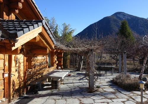 a log cabin with a bench in front of it at Le Gite de Briey - à 7 minutes de Vercorin in Chalais