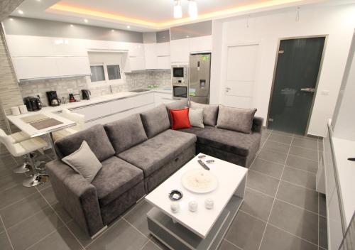a living room with a couch and a table at Le Gjero luxury villa in Ksamil