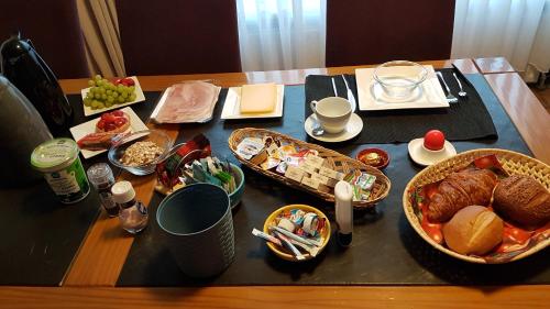a table topped with lots of food on top at BnbMarlies in Oorsbeek