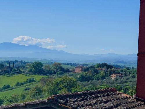 a view of the hills and mountains from a building at Hotel Santa Caterina in Siena