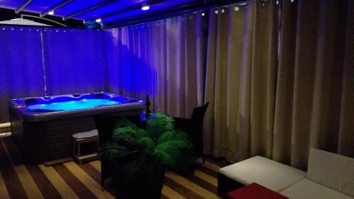 a bathroom with a jacuzzi tub with blue lighting at Villa Summer dream with heated pool, sauna and jacuzzi in Malinska