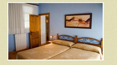 a bedroom with a bed in a blue room at Apartamentos Brisas del Deva in Potes