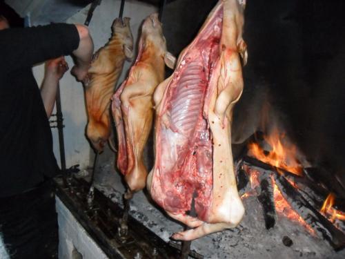 a group of meat being cooked on a grill at Antico Restauro in Fonni