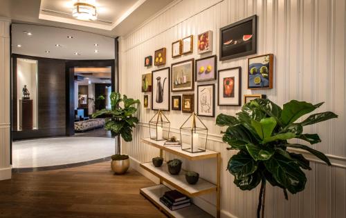 a hallway with a bunch of pictures on the wall at The Dupont Circle Hotel in Washington