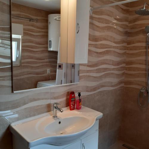 a bathroom with a sink and a mirror at Apartment "Mislav" in Gornji Karin