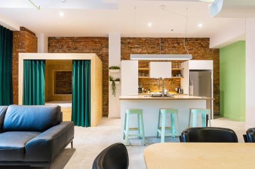 a kitchen and living room with a couch and a table at Les Lofts St-Roch - Par Les Lofts Vieux-Québec in Quebec City
