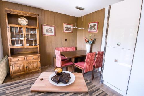 comedor con mesa y sillas rojas en Apartmaji Baron en Bled