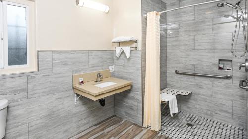 a bathroom with a sink and a shower at Sea Rock Inn - Long Beach in Long Beach