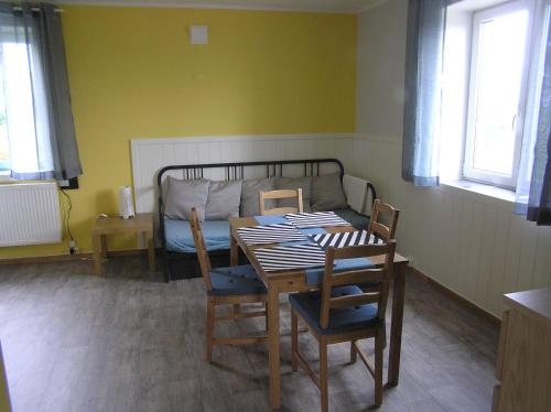 a room with a table and chairs and a bed at Bedder at Oslo Airport - serviced apartments in Jessheim
