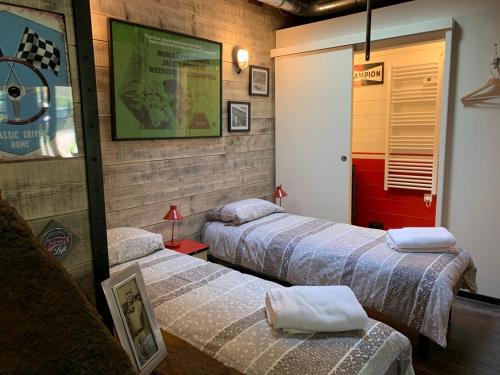 a room with three beds with towels on them at Classic Driver Home 1 in Royat