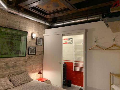 a bedroom with a bed and a wall at Classic Driver Home 1 in Royat
