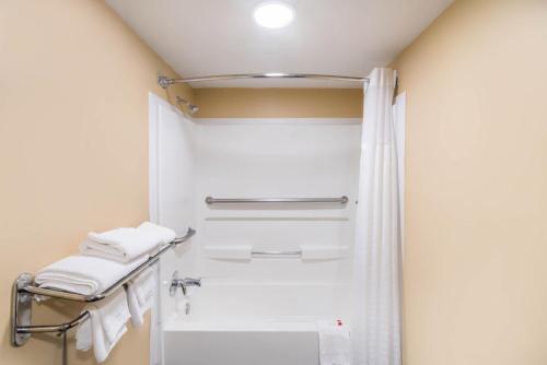 a bathroom with a shower with white towels at Baymont by Wyndham Franklin in Franklin
