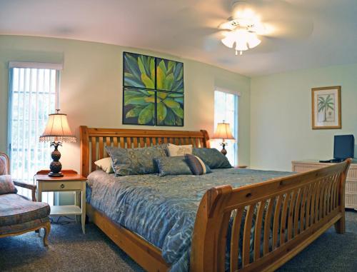 a bedroom with a bed and a couch and a chair at Crescent Beach 1011 #3 in Sarasota