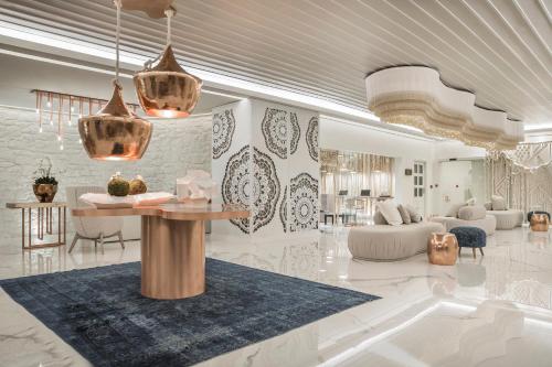 a rendering of a living room and dining room at Palladium Hotel in Platis Yialos Mykonos