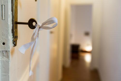 a door knob with a white bow on it at Room En Suite la Corte Assisi in Assisi